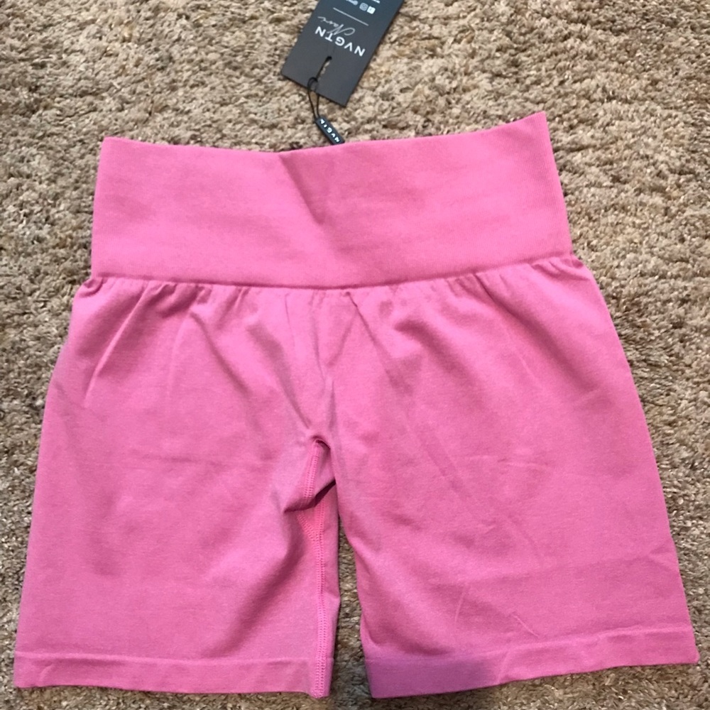 Hot pink NVGTN shorts.